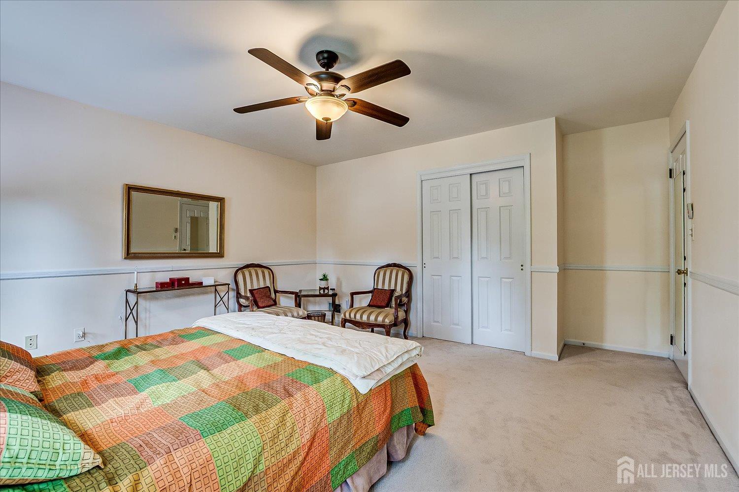 2 Pine Ridge Drive Edison, NJ 08820 - Photo 35 of 50 a bedroom with a bed and a chandelier