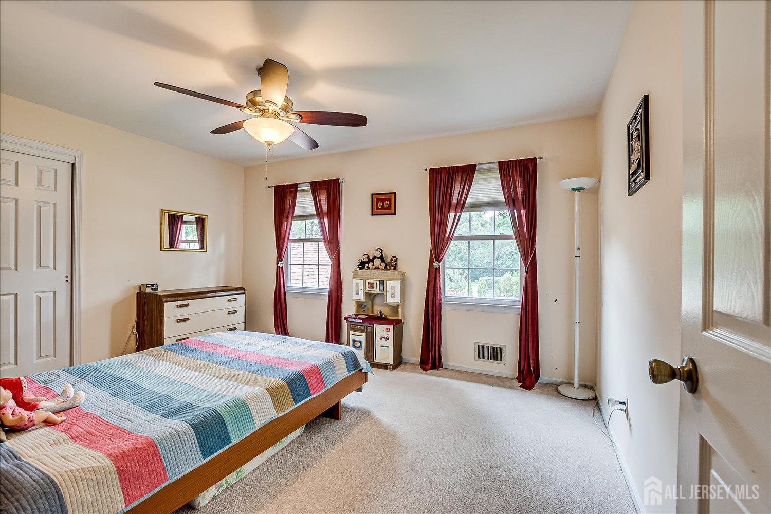 2 Pine Ridge Drive Edison, NJ 08820 - Photo 36 of 50 a bedroom with a large bed and a chandelier