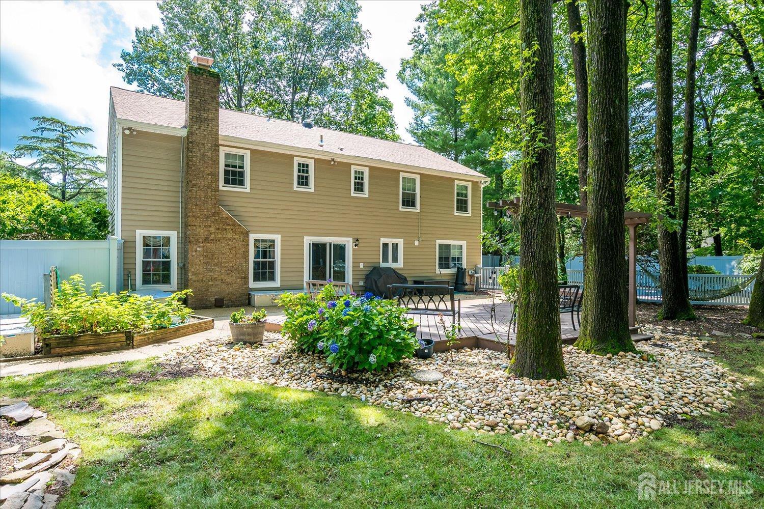 2 Pine Ridge Drive Edison, NJ 08820 - Photo 41 of 50 a view of a house with a yard and plants