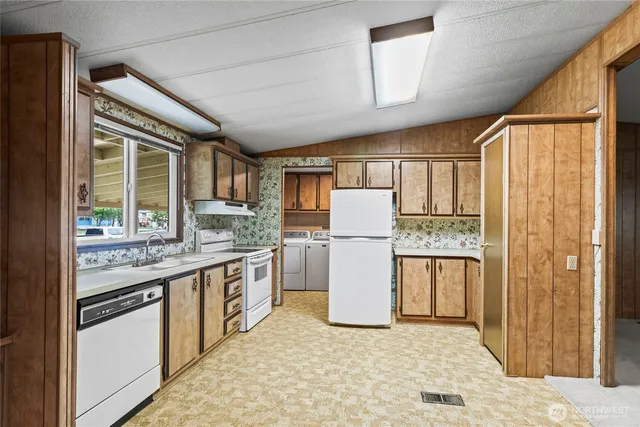 a kitchen with refrigerator and cabinets