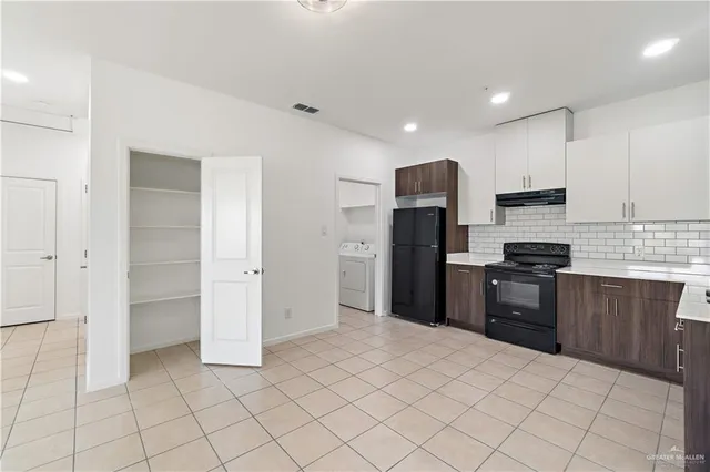 a bathroom with a double vanity sink toilet and shower