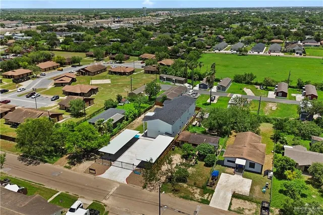 an aerial view of multiple houses with yard