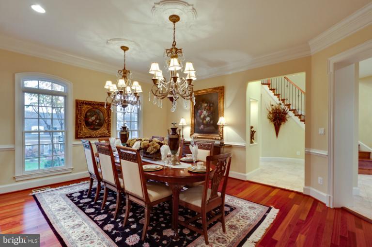 903 Georgetown Ridge Court McLean, VA 22102 - Photo 2 of 27 a view of a dining room with furniture wooden floor and chandelier