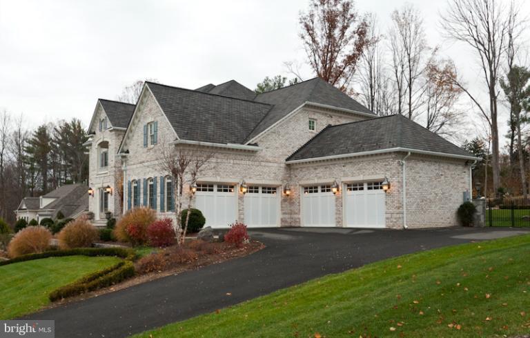 903 Georgetown Ridge Court McLean, VA 22102 - Photo 15 of 27 a view of a white house next to a yard and large trees