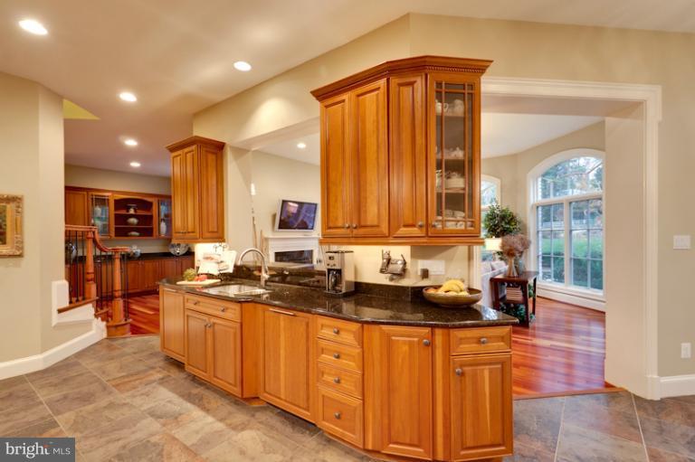 903 Georgetown Ridge Court McLean, VA 22102 - Photo 17 of 27 a kitchen with stainless steel appliances granite countertop a sink stove and cabinets