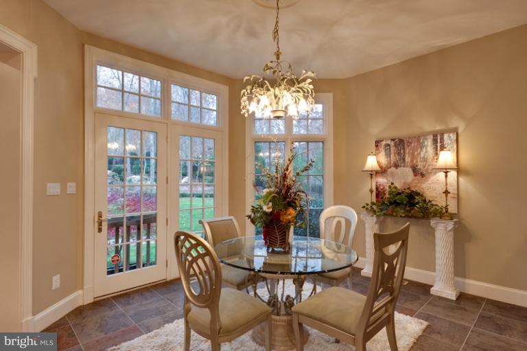 903 Georgetown Ridge Court McLean, VA 22102 - Photo 3 of 27 a view of a dining room with furniture a chandelier and wooden floor