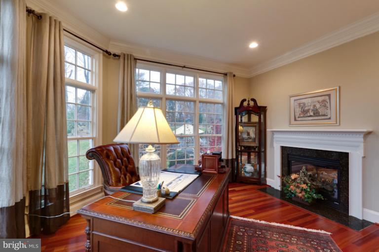 903 Georgetown Ridge Court McLean, VA 22102 - Photo 7 of 27 a living room with furniture a window and a fireplace