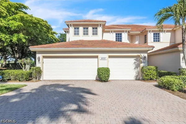 a front view of a house with a yard and garage