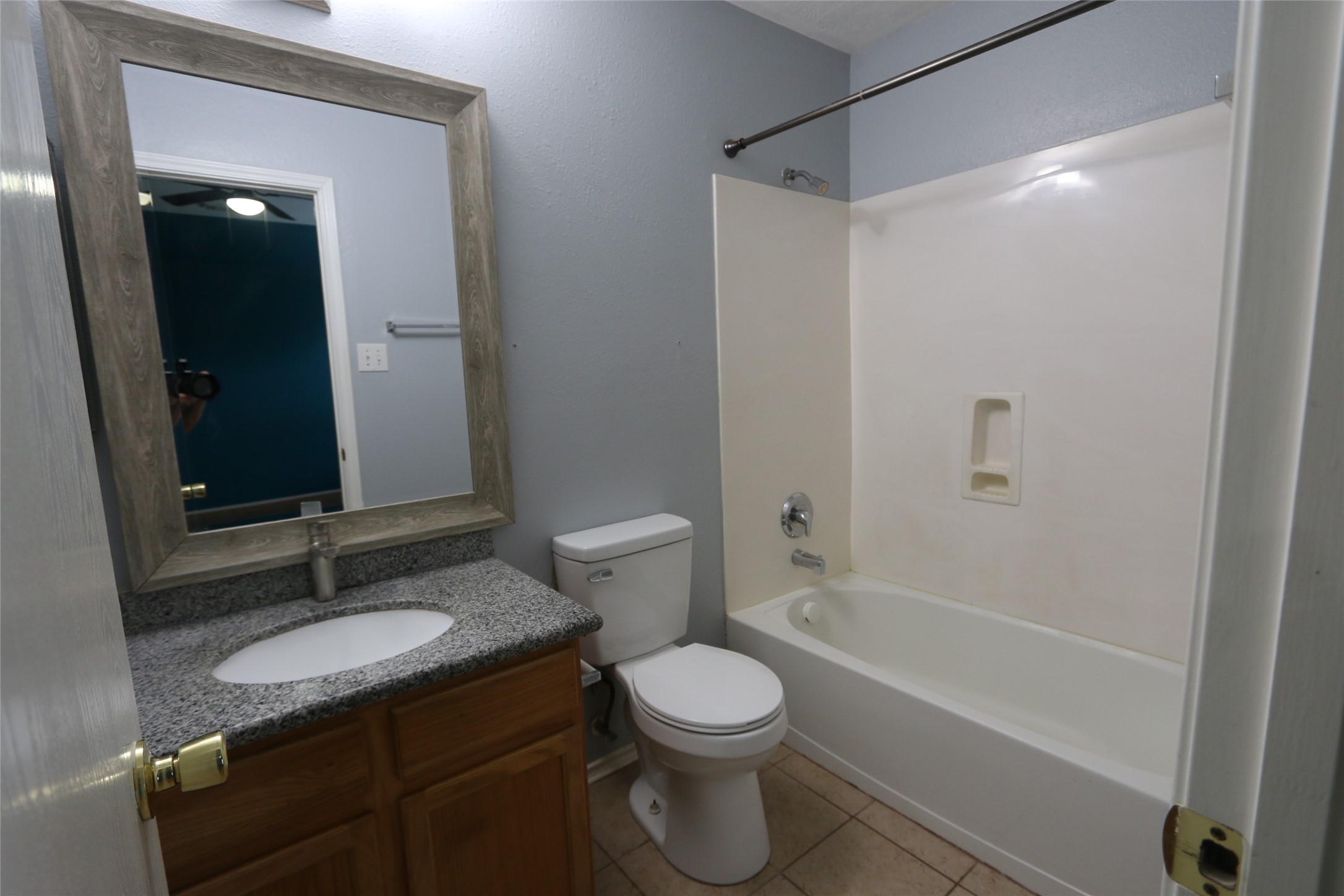 5914 Ridgebriar Lane Houston, TX 77085 - Photo 3 of 8 a bathroom with a granite countertop sink toilet a mirror and shower