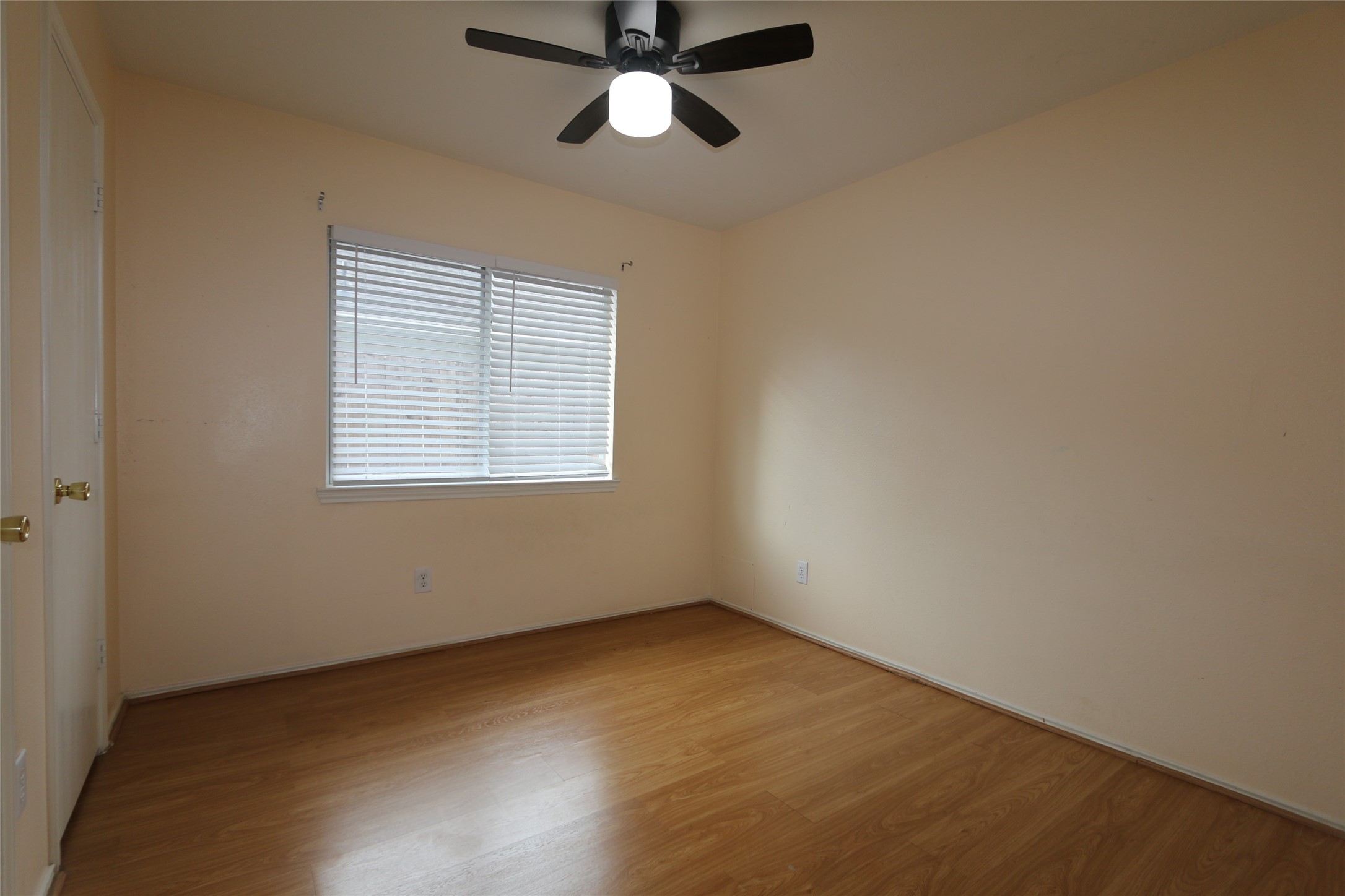 5914 Ridgebriar Lane Houston, TX 77085 - Photo 5 of 8 an empty room with a window and a fan