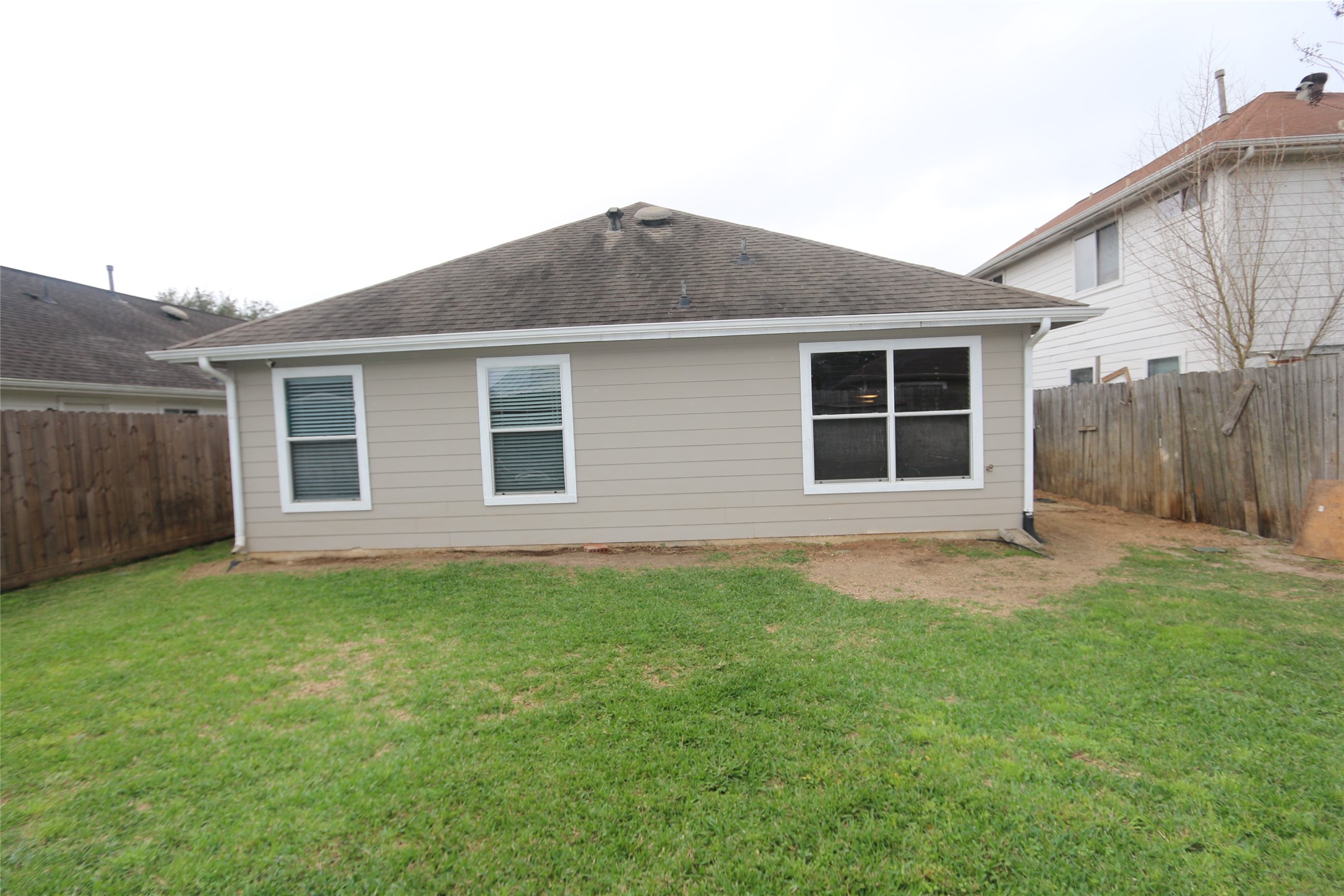 5914 Ridgebriar Lane Houston, TX 77085 - Photo 8 of 8 a backyard of a house with plants and large tree
