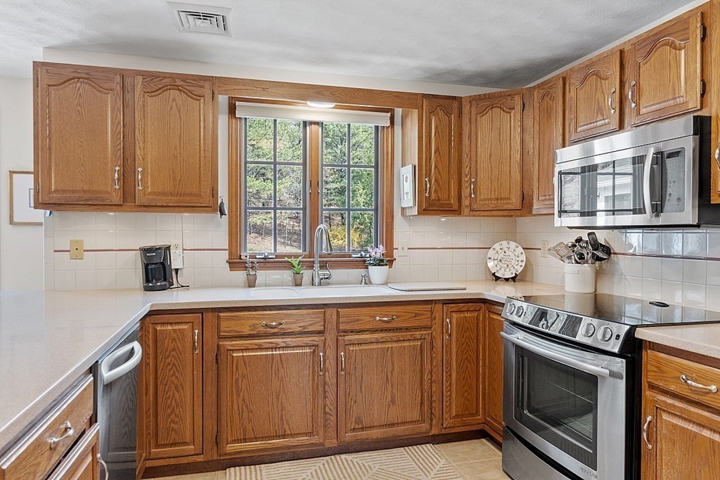 134 Houghton's Mill Road Lunenburg, MA 01462 - Photo 3 of 37 a kitchen with cabinets appliances a sink and a counter top space