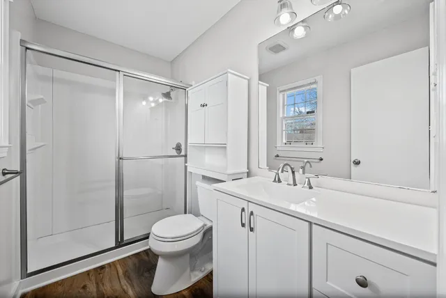 a bathroom with a sink toilet and shower