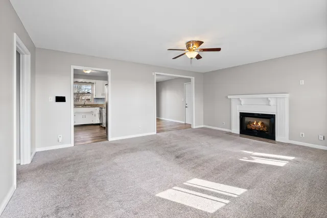 a view of an empty room with a fireplace