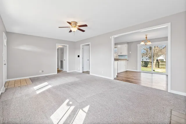 a view of a livingroom with a ceiling fan and window