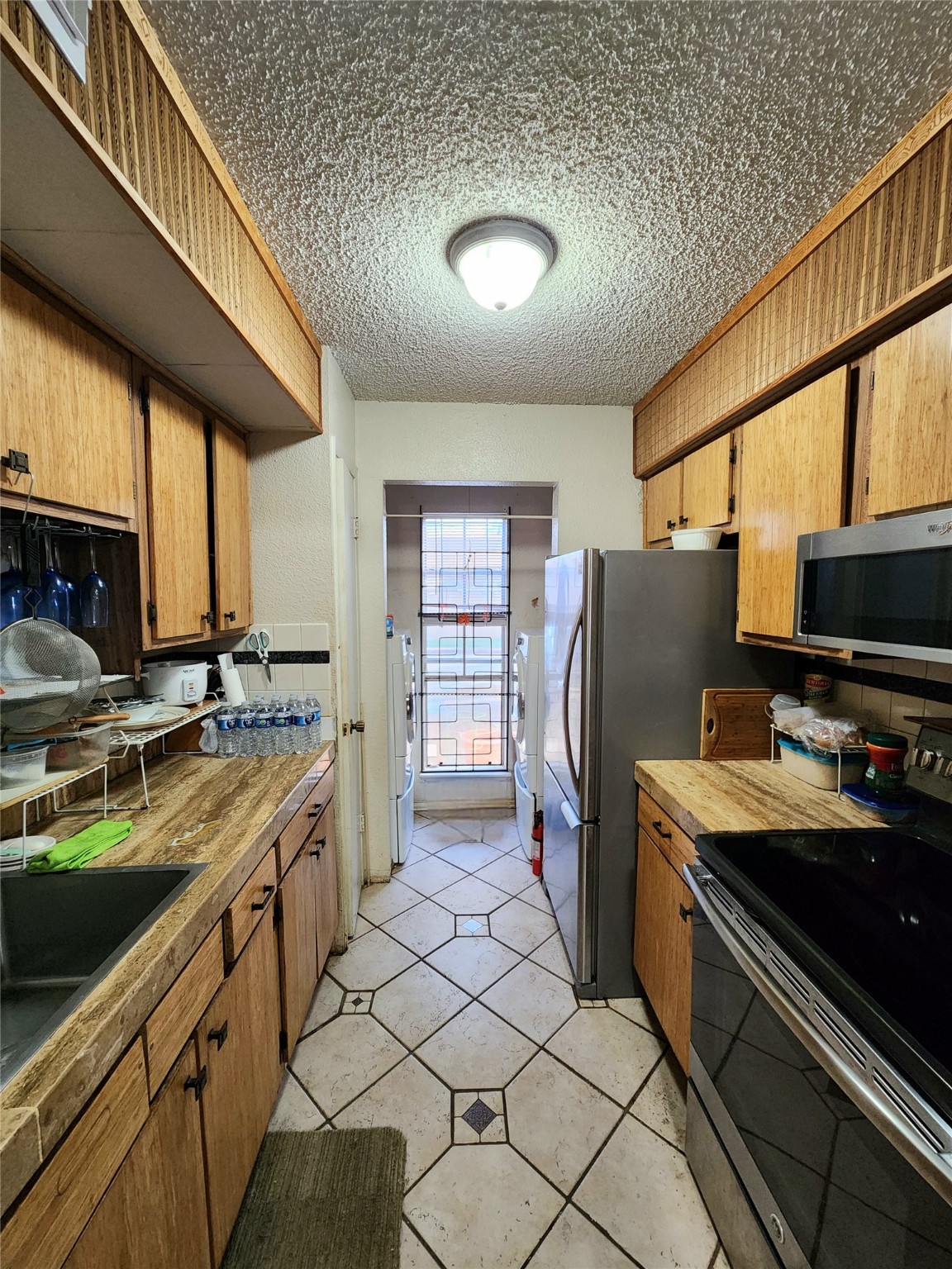 1505 Ward Road, Unit 161 Baytown, TX 77520 - Photo 3 of 10 a kitchen with stainless steel appliances granite countertop a sink stove and refrigerator