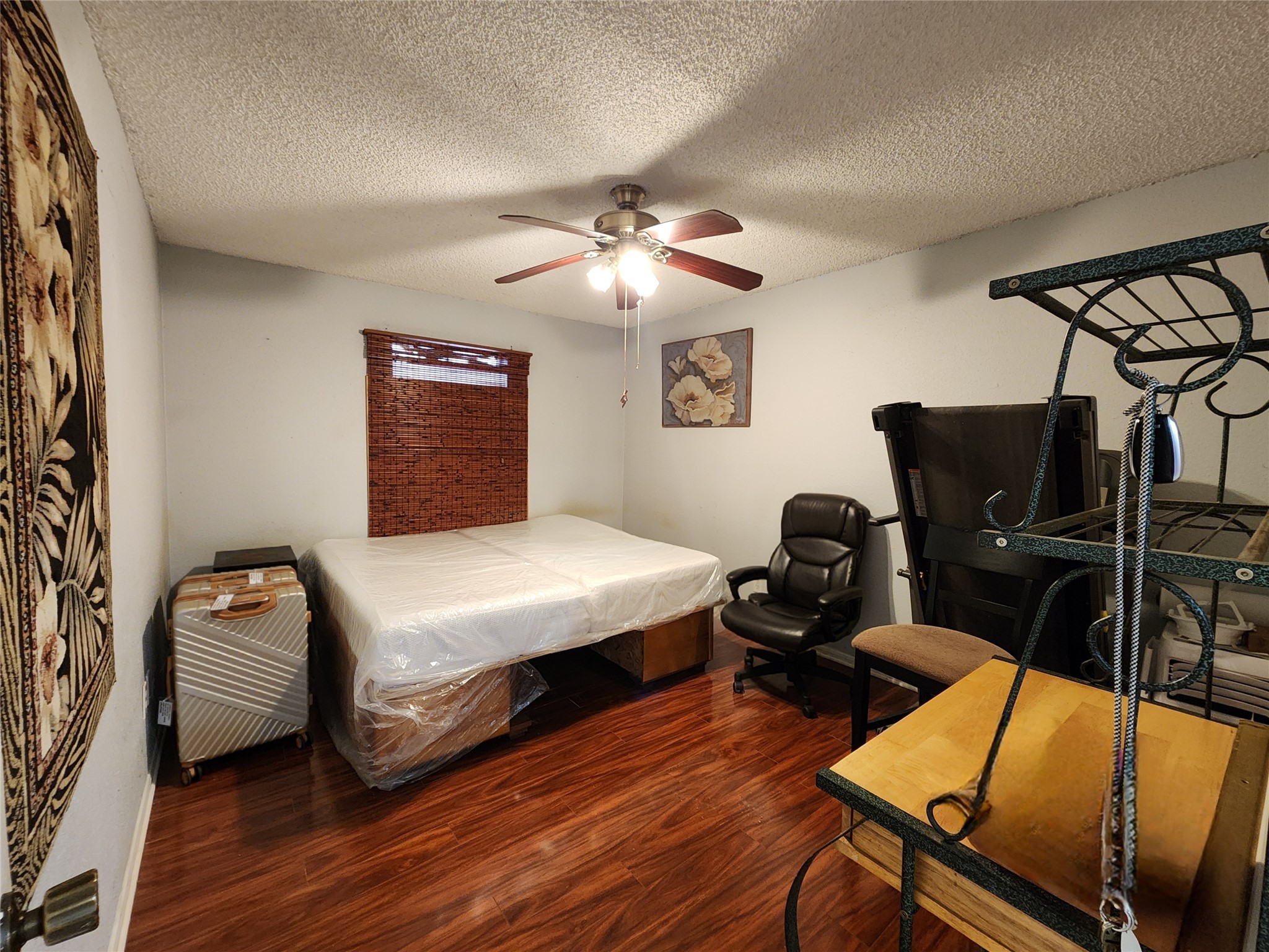 1505 Ward Road, Unit 161 Baytown, TX 77520 - Photo 4 of 10 a bedroom with a bed and wooden floor