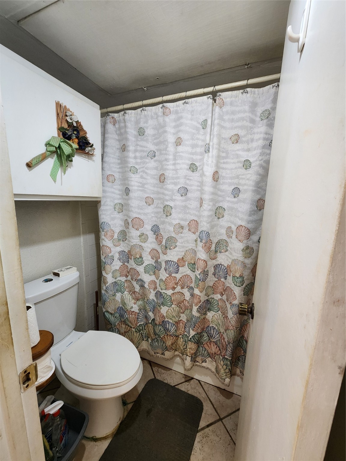 1505 Ward Road, Unit 161 Baytown, TX 77520 - Photo 7 of 10 a bathroom with a toilet and a shower curtain