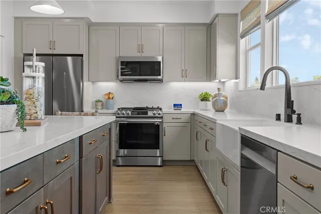 a kitchen with appliances a sink and cabinets