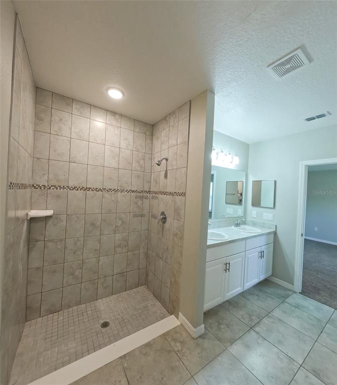 3381 Southwest 129th Loop Ocala, FL 34473 - Photo 23 of 35 a bathroom with a granite countertop sink a toilet and shower