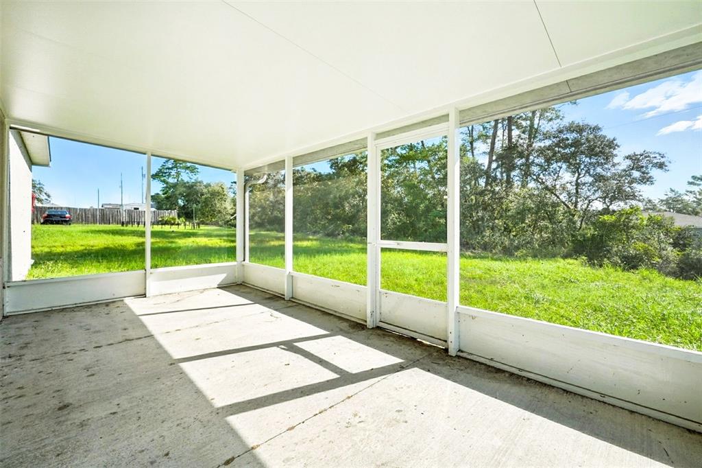 3381 Southwest 129th Loop Ocala, FL 34473 - Photo 27 of 35 a view of an empty room with a large windows