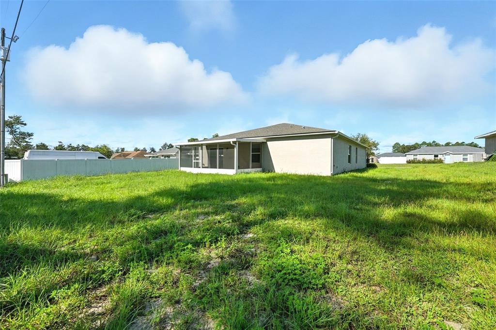 3381 Southwest 129th Loop Ocala, FL 34473 - Photo 28 of 35 a view of a house with a big yard and large trees
