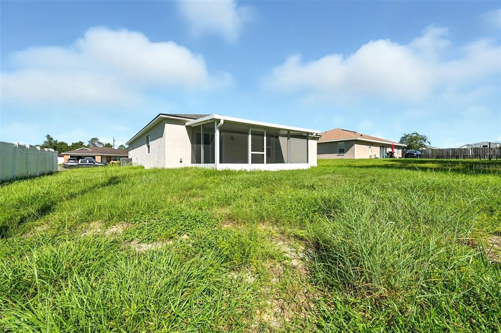 3381 Southwest 129th Loop Ocala, FL 34473 - Photo 29 of 35 a view of a house with a yard and sitting area