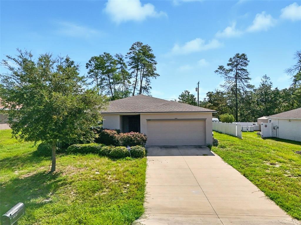3381 Southwest 129th Loop Ocala, FL 34473 - Photo 3 of 35 a front view of a house with garden