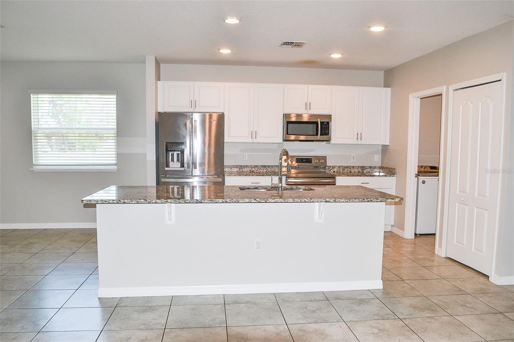 3381 Southwest 129th Loop Ocala, FL 34473 - Photo 10 of 35 a kitchen with stainless steel appliances granite countertop a refrigerator and a stove