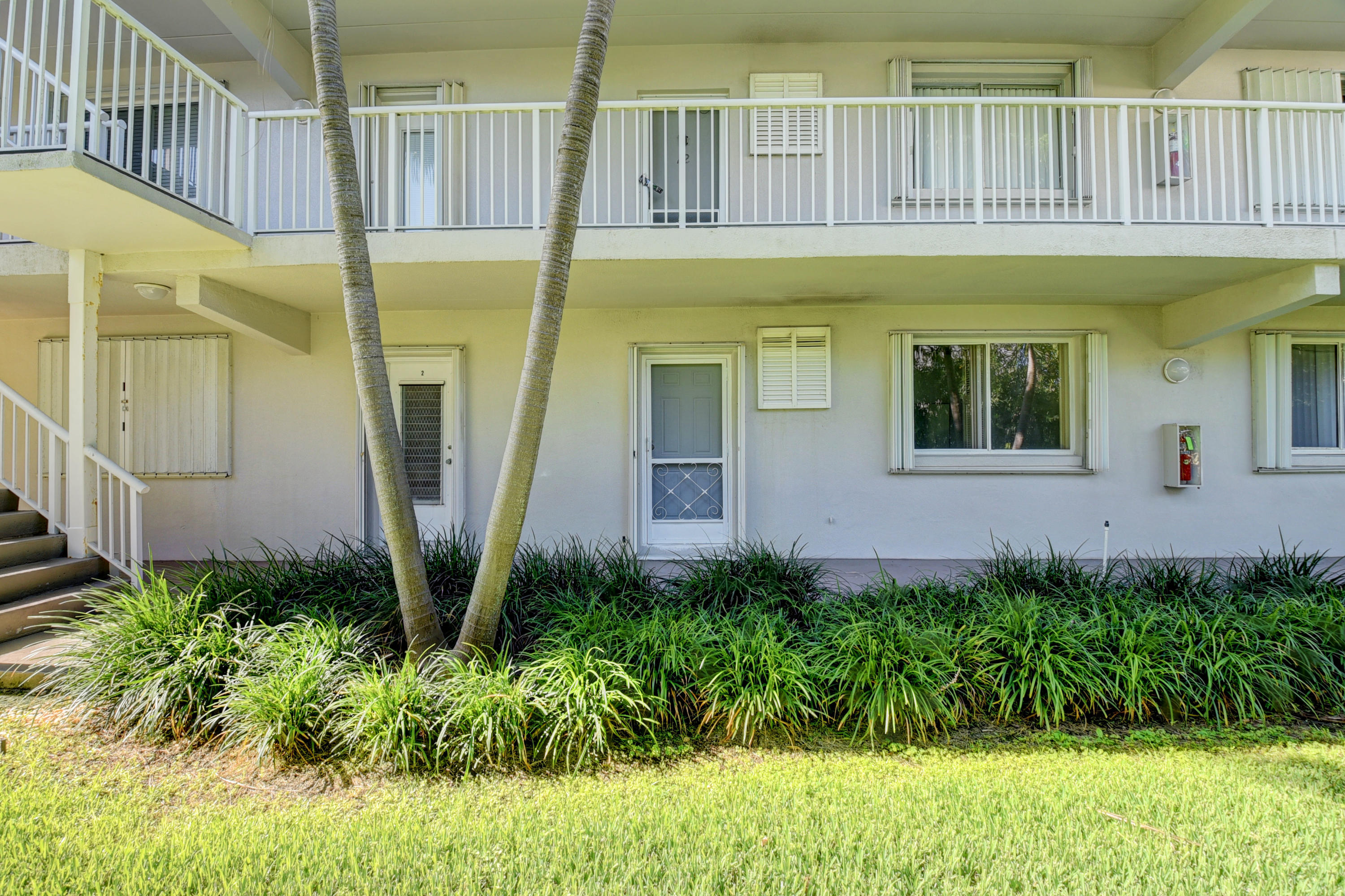 2700 Banyan Road, Unit 2C Boca Raton, FL 33432 - Photo 11 of 33 a front view of a house with a yard