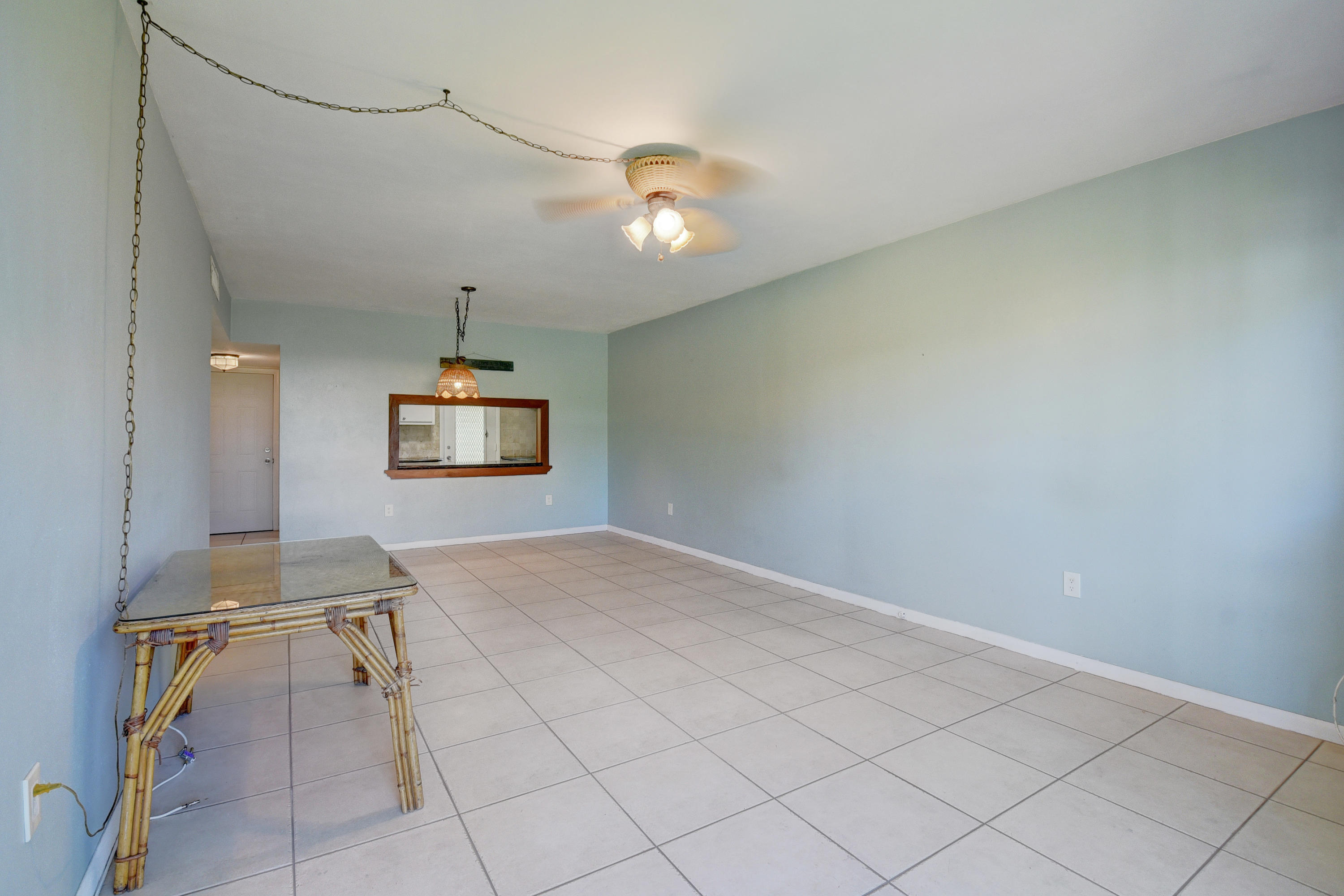 2700 Banyan Road, Unit 2C Boca Raton, FL 33432 - Photo 16 of 33 a view of a hallway with wooden floor and a chandelier