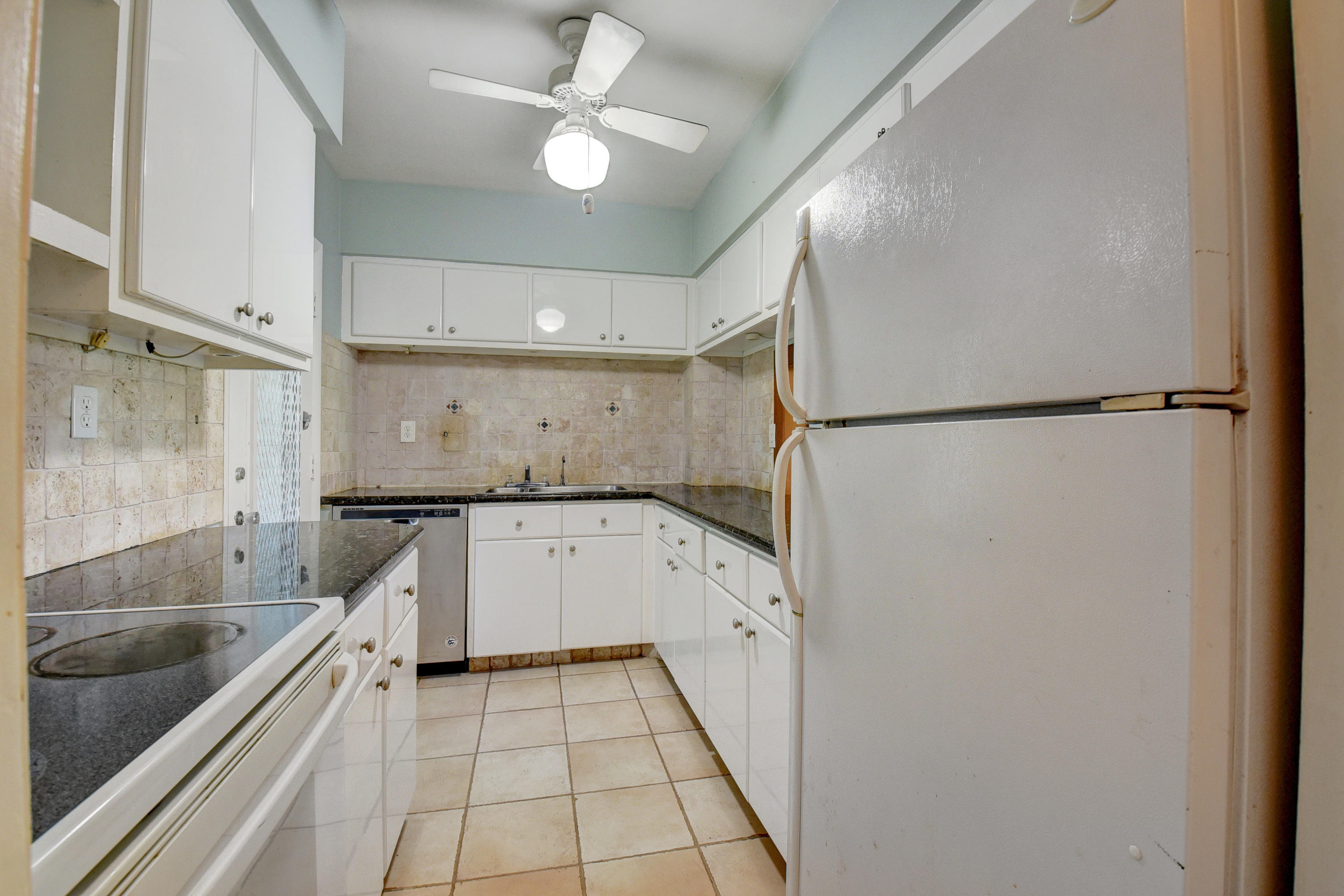2700 Banyan Road, Unit 2C Boca Raton, FL 33432 - Photo 19 of 33 a kitchen with a refrigerator a sink and dishwasher
