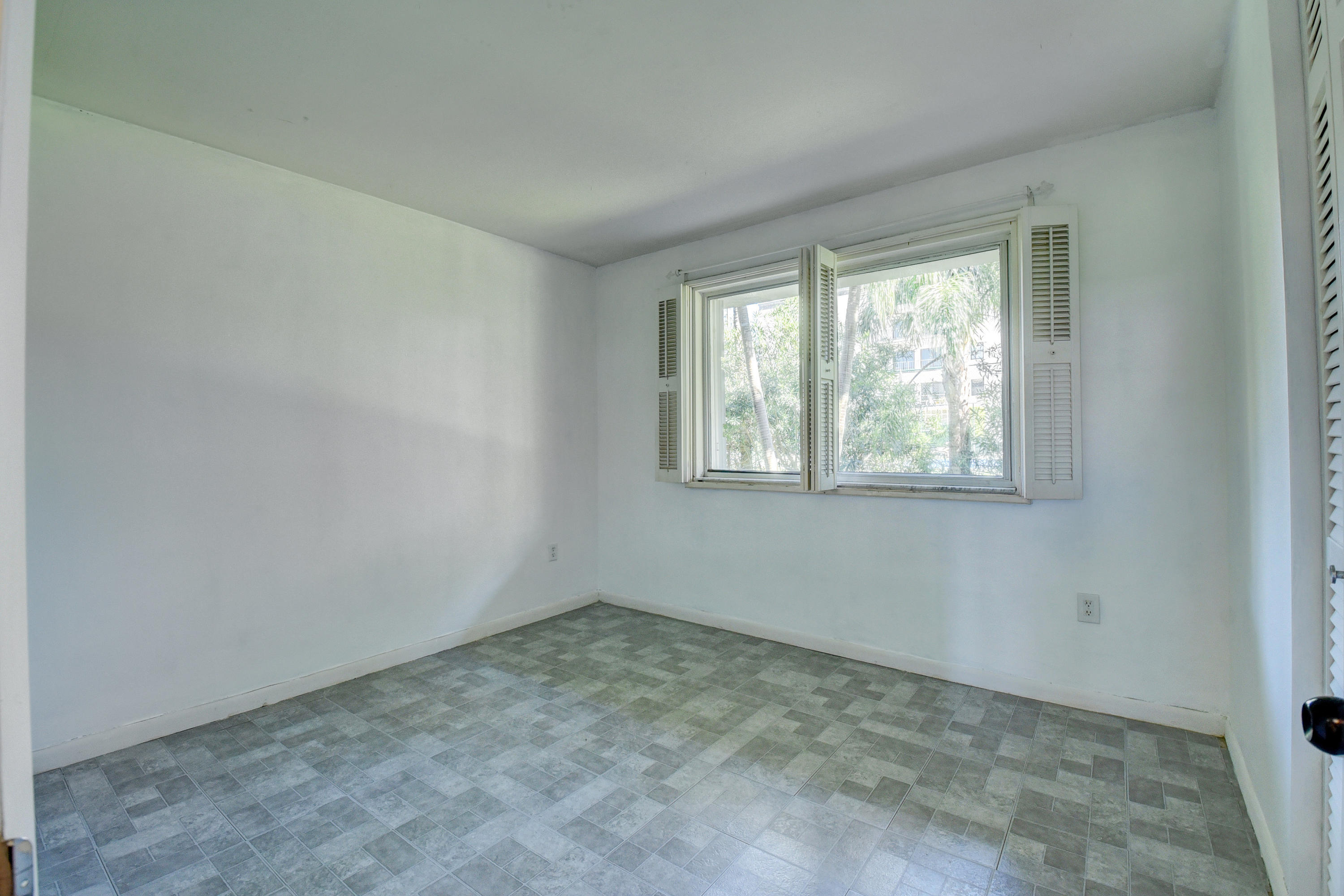 2700 Banyan Road, Unit 2C Boca Raton, FL 33432 - Photo 23 of 33 an empty room with a window