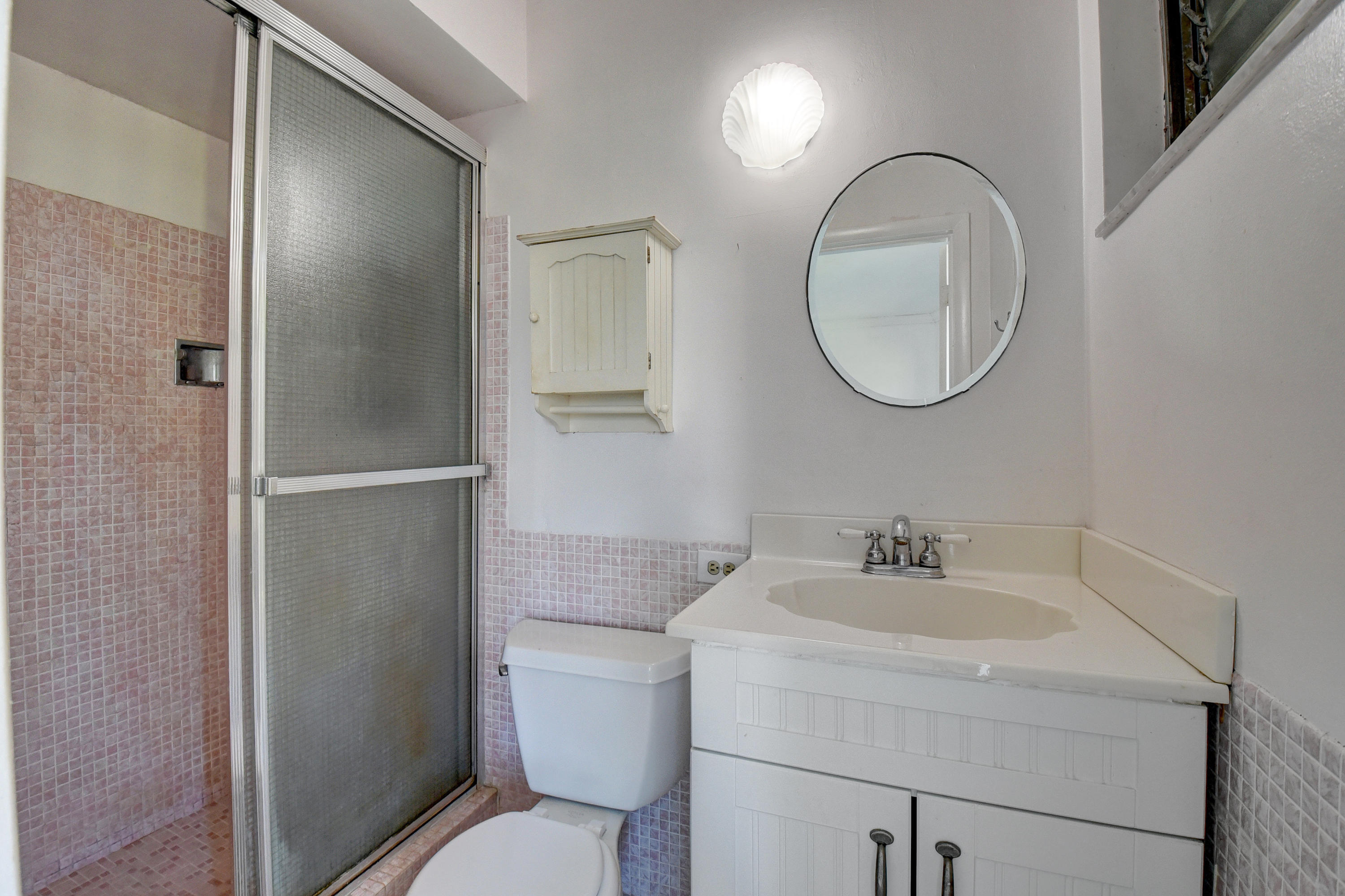 2700 Banyan Road, Unit 2C Boca Raton, FL 33432 - Photo 28 of 33 a bathroom with a toilet sink and a mirror