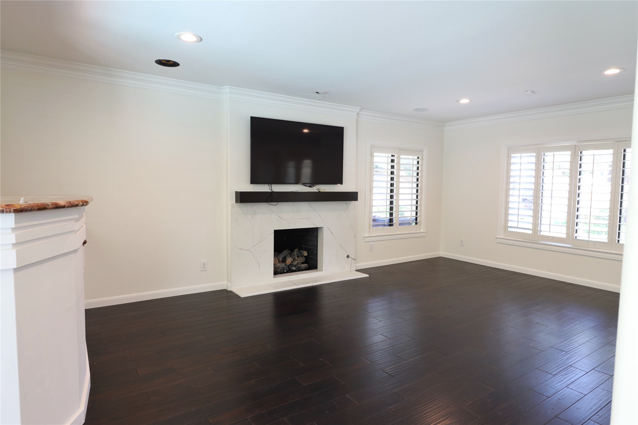 2003 Chilton Road Houston, TX 77019 - Photo 8 of 17 Here is a picture of the formal living space high-lighting the rich "hardwood floors", the sleek fireplace with stone surround, recessed lighting, and plantation shutters. Landlord recently redid the stone around the fireplace to make the room more current. You will enjoy this bright and cheerful space for everyday living and entertaining. TV remains during lease.