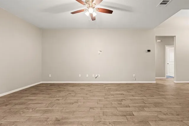 a bathroom with a granite countertop sink a toilet a mirror and shower