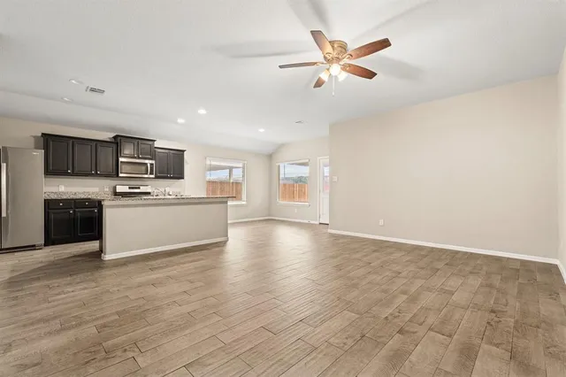 a view of kitchen with microwave and stove top oven