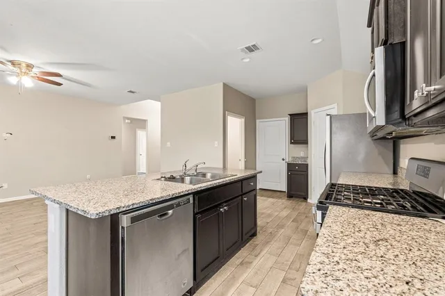a kitchen with a sink stove and refrigerator