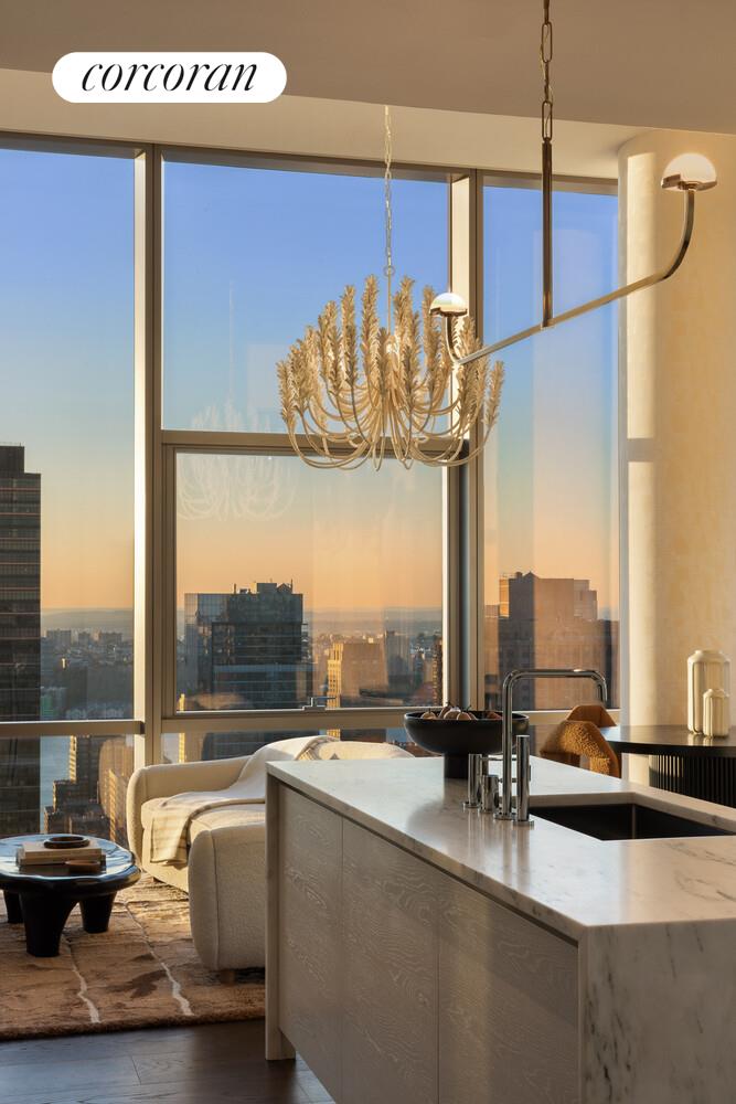 50 West 66th Street, Unit 41W Manhattan, NY 10023 - Photo 15 of 69 a view of a living room with a table and chair