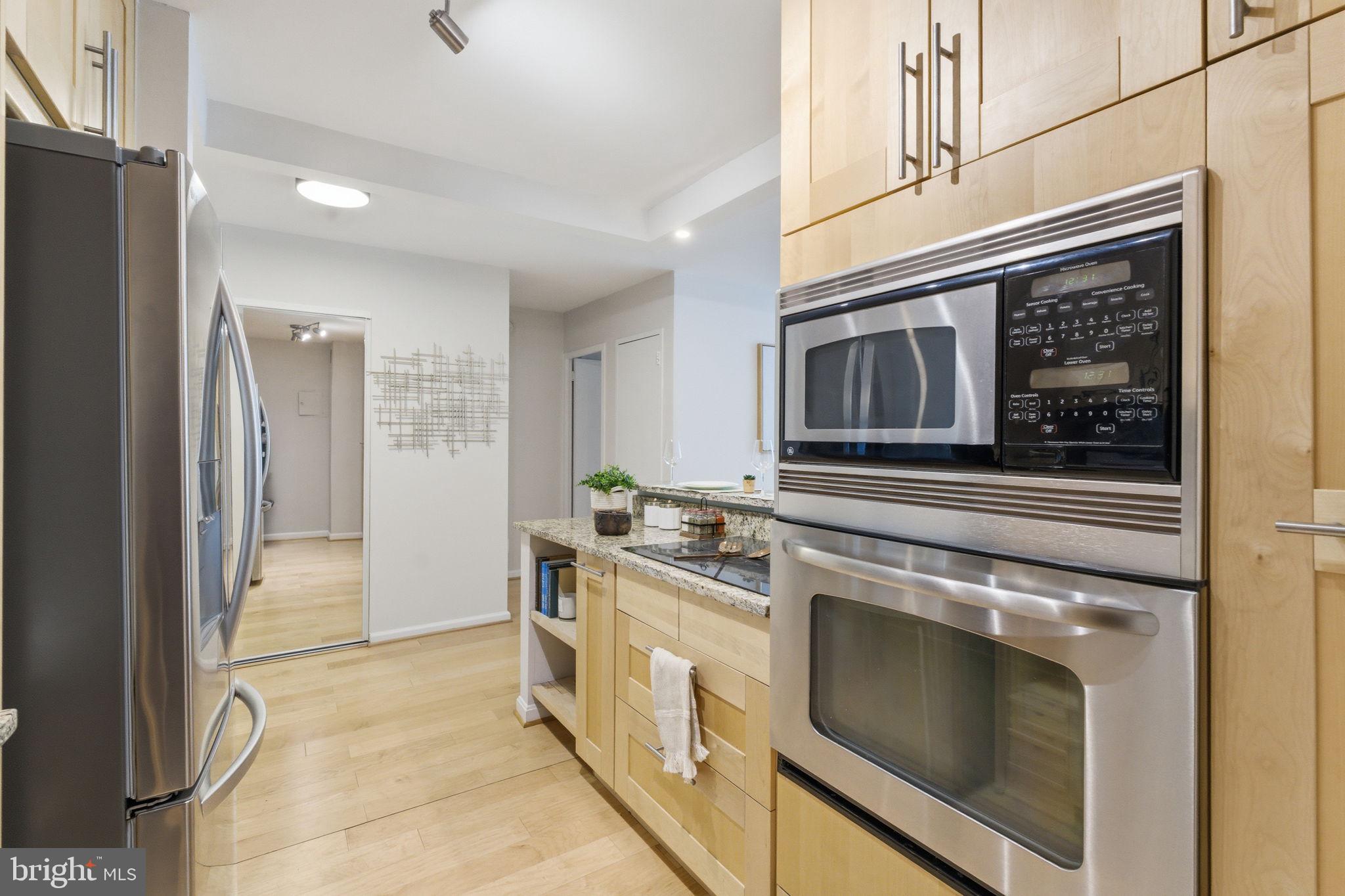 1435 4th Street Southwest, Unit B609 Washington, DC 20024 - Photo 21 of 52 a kitchen with stainless steel appliances granite countertop a stove and a refrigerator