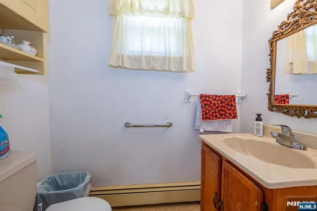 a bathroom with a toilet and a shower curtain
