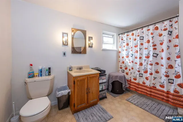 a view of backyard with a chair and table in the patio