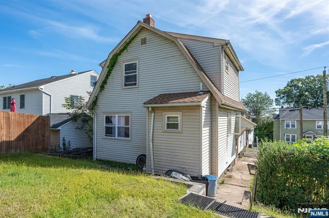 a view of a house with a yard and plants