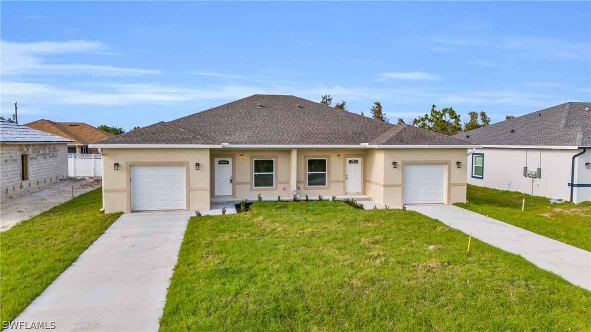 a front view of a house with a yard and garage