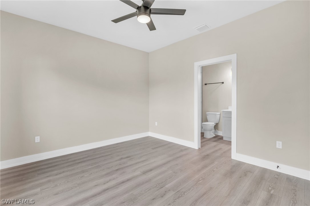 12208 Tetzel Avenue Port Charlotte, FL 33981 - Photo 19 of 45 a view of a room with wooden floor and white walls