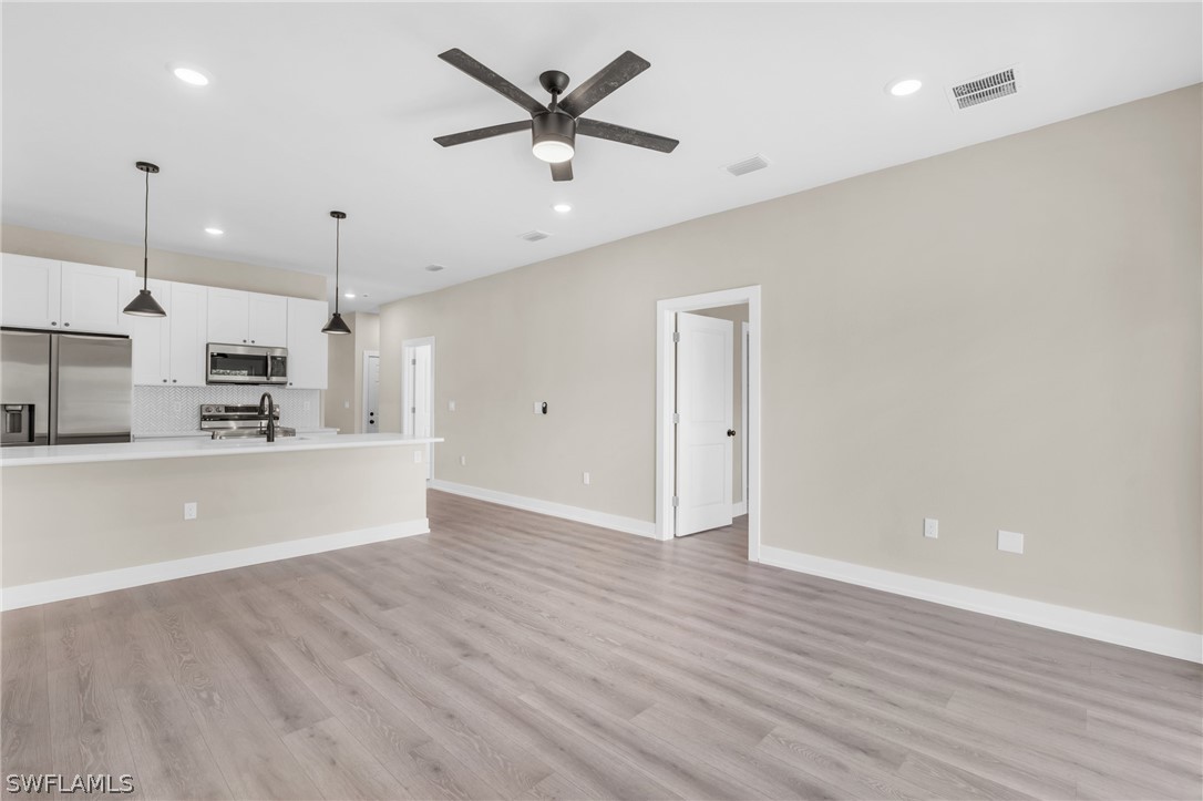 12208 Tetzel Avenue Port Charlotte, FL 33981 - Photo 22 of 45 a view of kitchen with stainless steel appliances refrigerator oven and cabinets