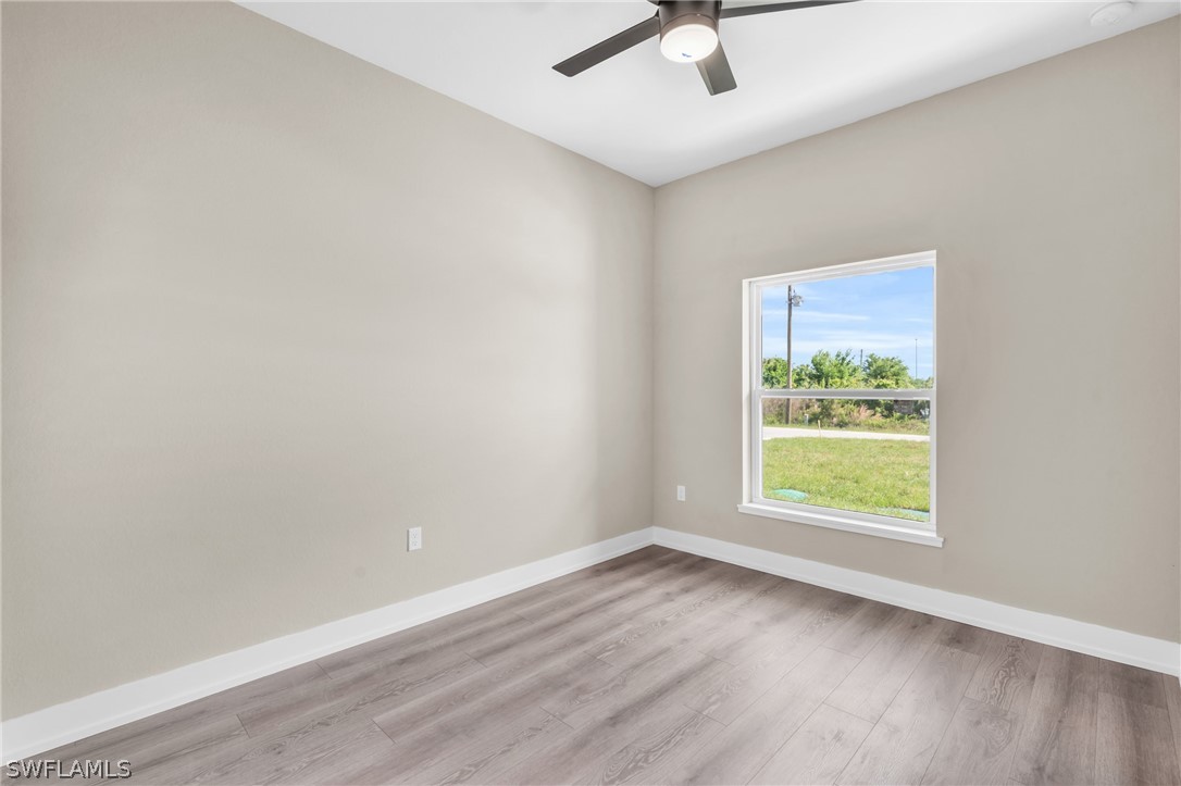 12208 Tetzel Avenue Port Charlotte, FL 33981 - Photo 27 of 45 an empty room with a window and a ceiling fan