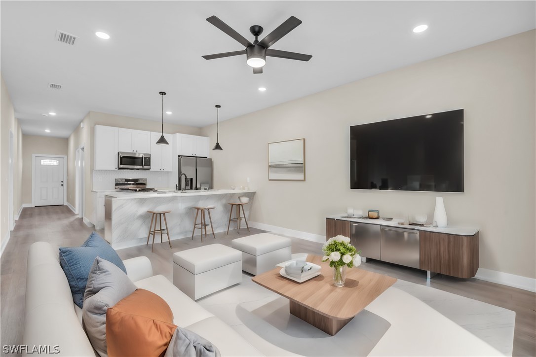 12208 Tetzel Avenue Port Charlotte, FL 33981 - Photo 3 of 45 a living room with furniture and a flat screen tv