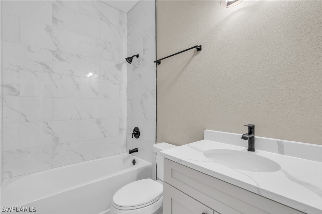 12208 Tetzel Avenue Port Charlotte, FL 33981 - Photo 34 of 45 a bathroom with a sink a toilet and a bathtub