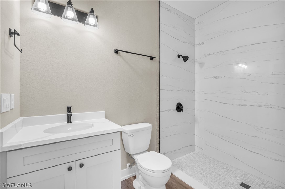 12208 Tetzel Avenue Port Charlotte, FL 33981 - Photo 7 of 45 a bathroom with a sink a toilet and shower